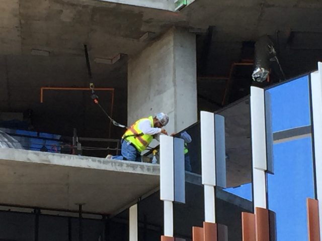 Construction worker installing exterior rib